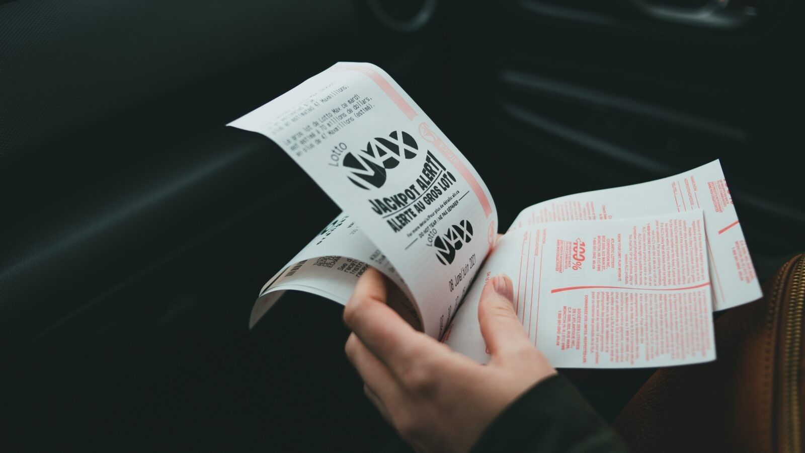 person holding lottery tickets