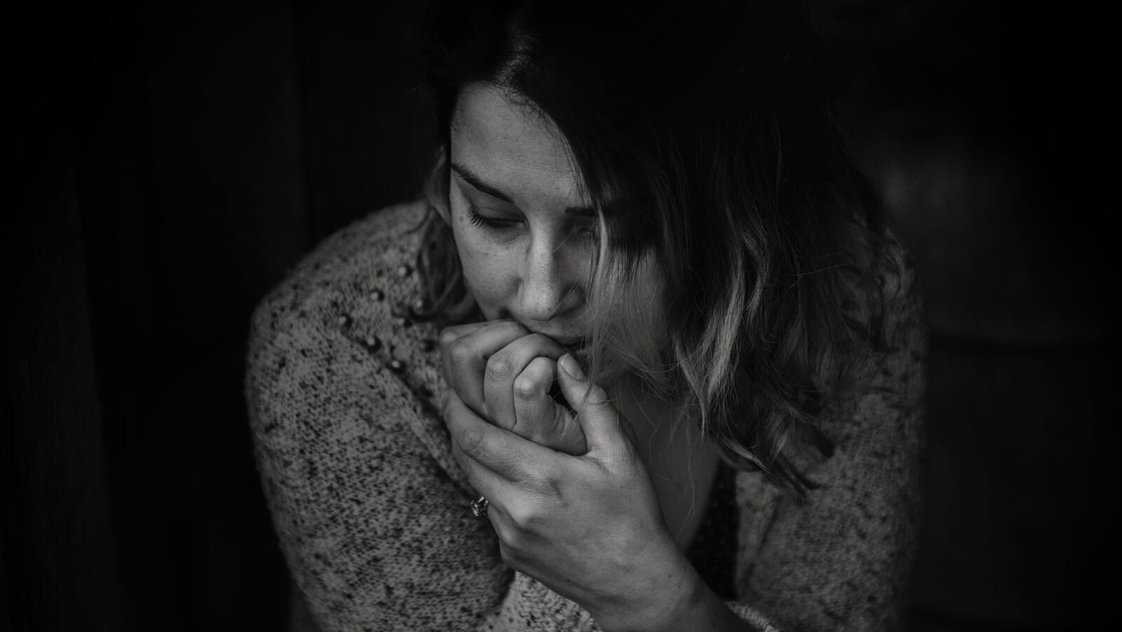 greyscale photo of woman wearing a long sleeve top