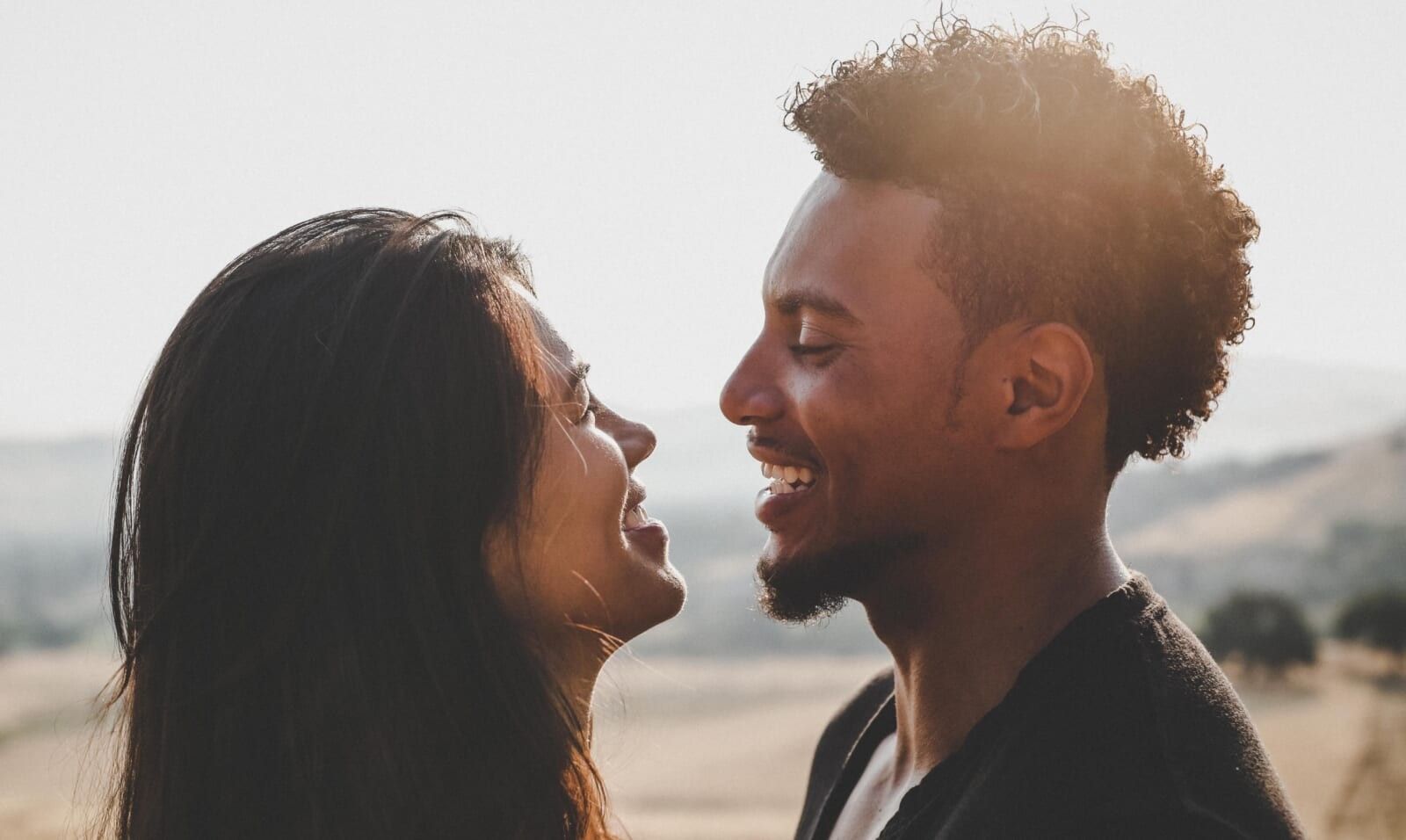 young couple flirting outside smiling