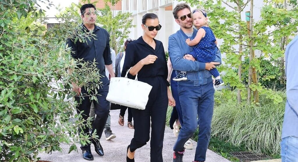 Bradley Cooper and Irina Shayk with daughter walking down the street.