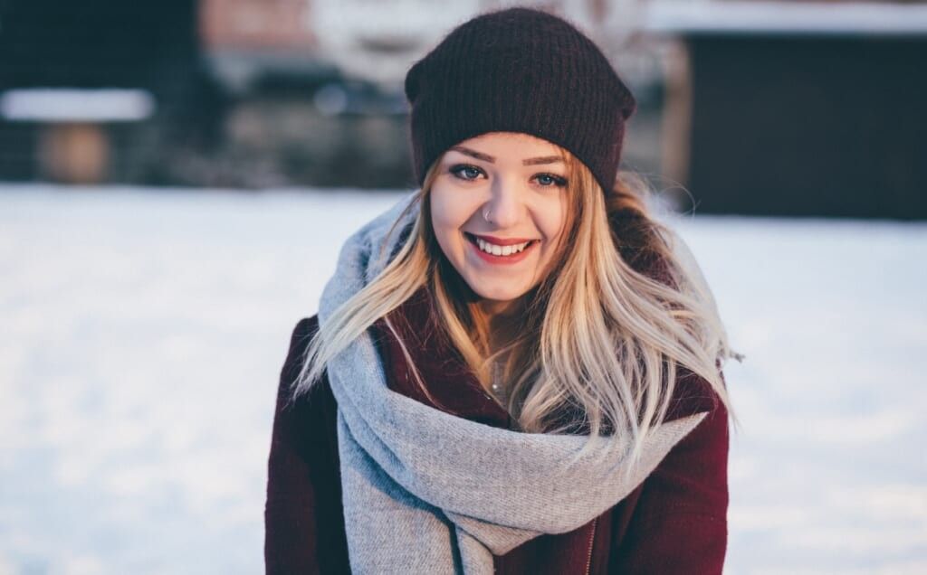 woman stands outside smiling