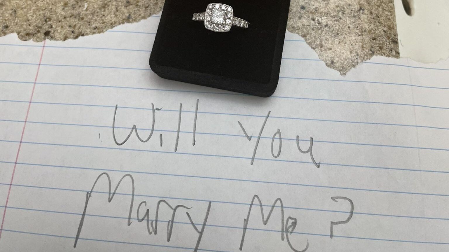 a ring in a box and a note that says 
