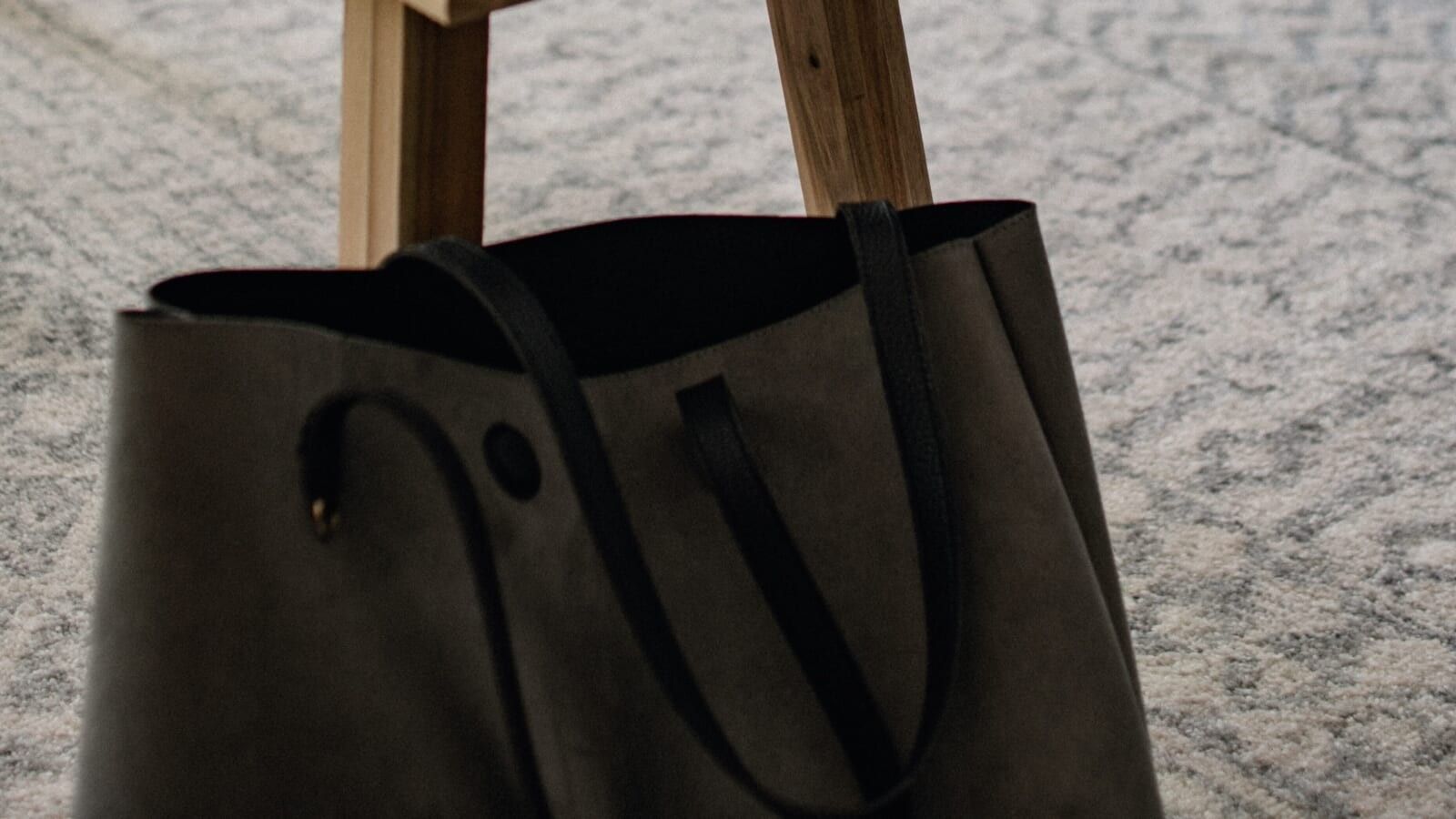 black bag leaning against a table