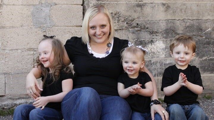 woman sitting with three children
