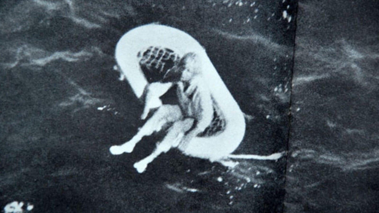 little girl floating on a small boat in the sea