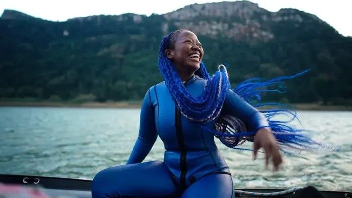 woman with blue hair sitting on a boat