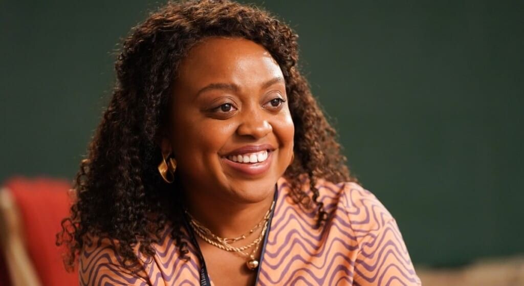 Quinta Brunson from Abbott Elementary in orange and purple hair smiling at the camera.