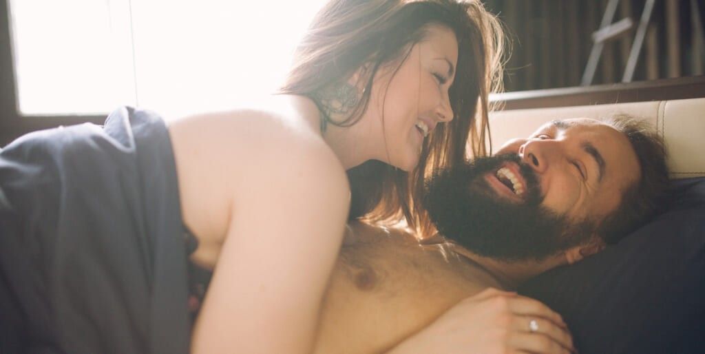 Young Beautiful Man With A Woman Sleeping In The Bed. View From Above.