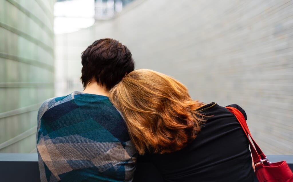 two people comforting each other