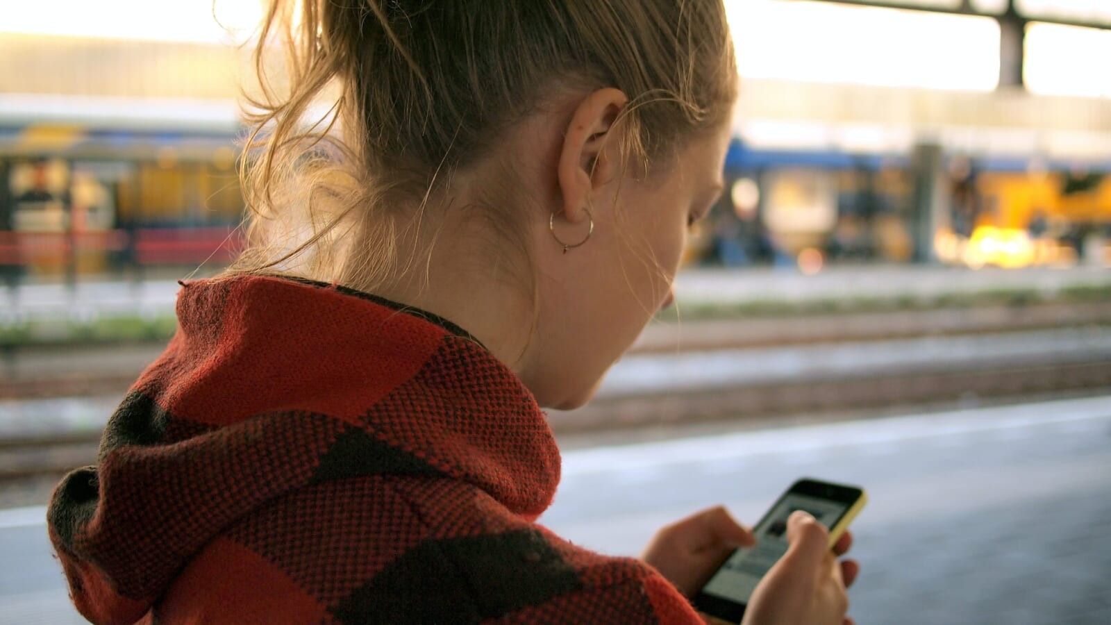 woman looking at a phone in her hand