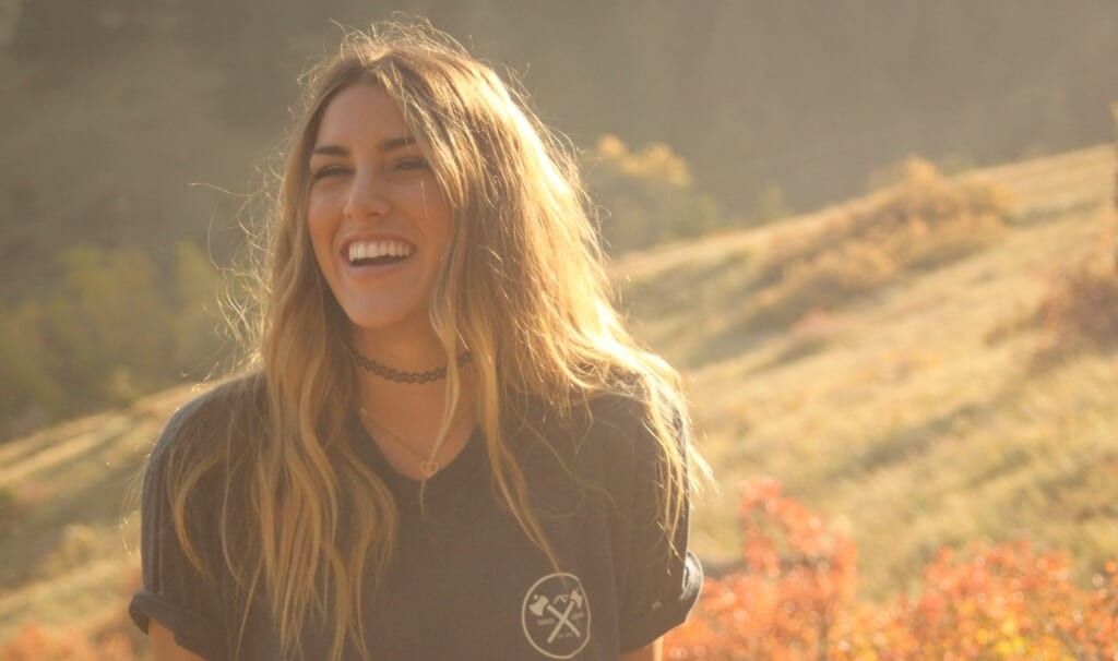 young woman laughs at question