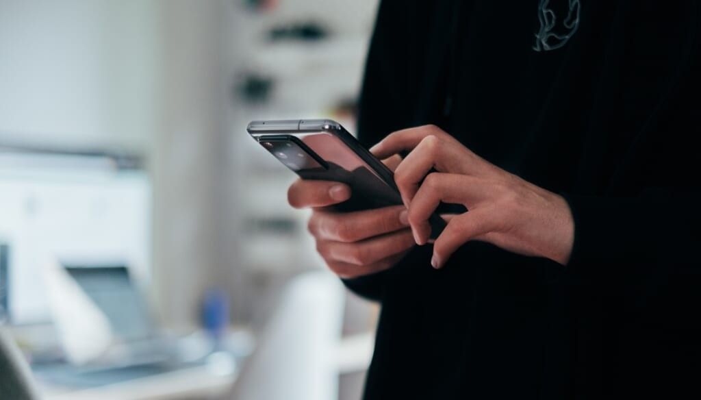 hand holding a phone indoors