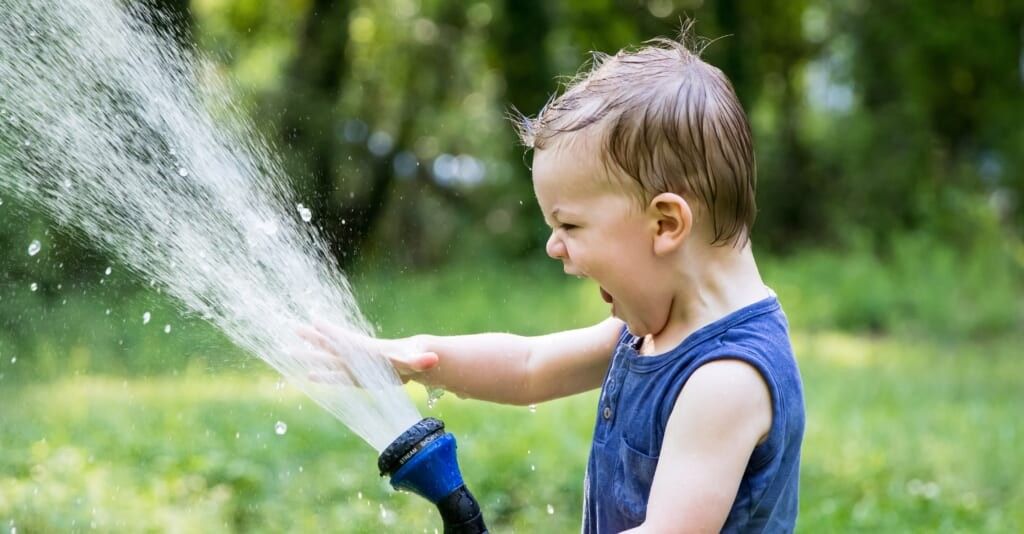 child playing with hose