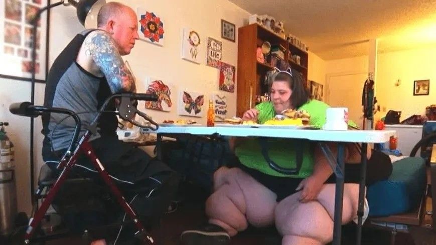 a man and woman eating food at a table