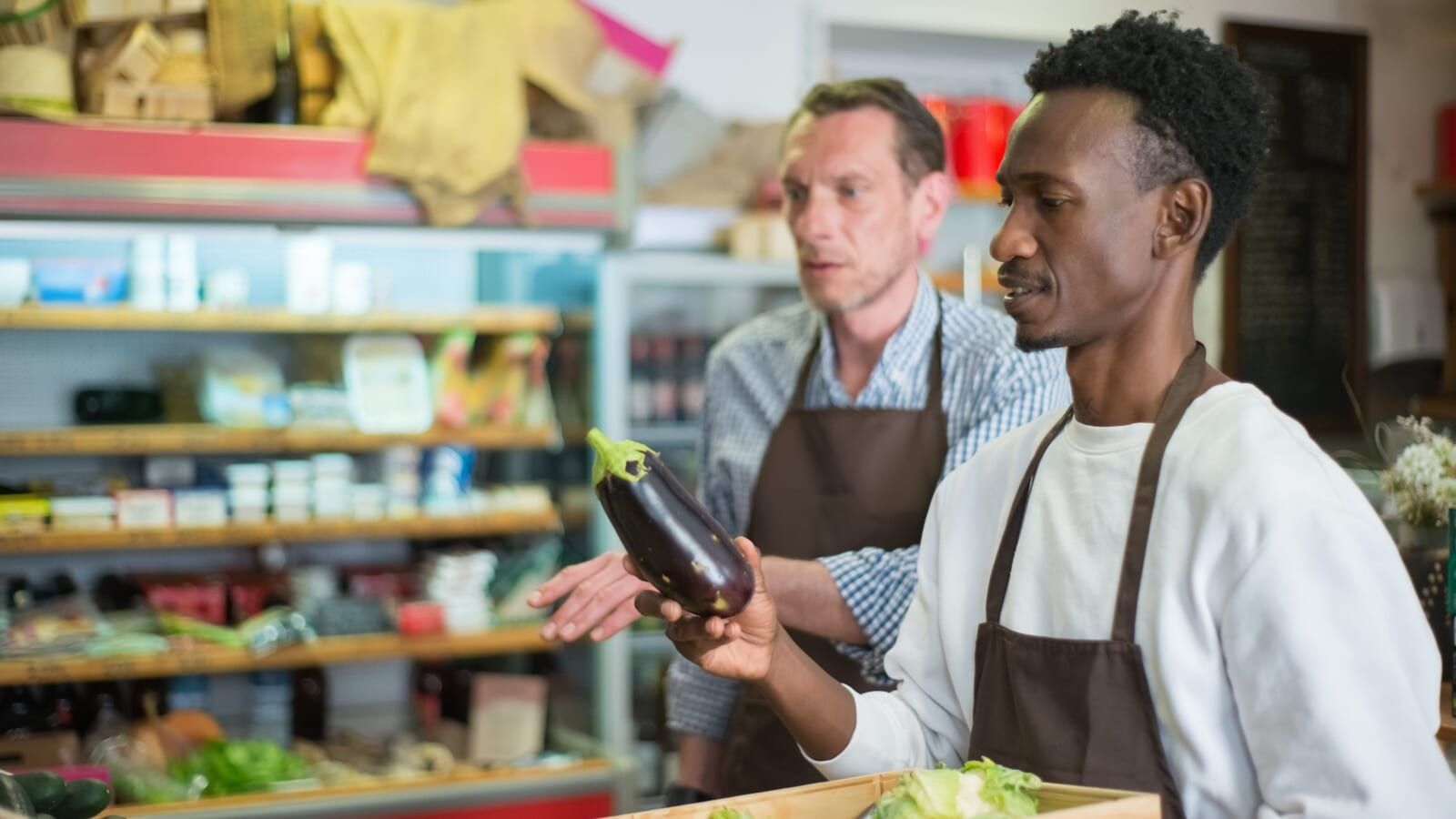 grocery store worker with vegetables