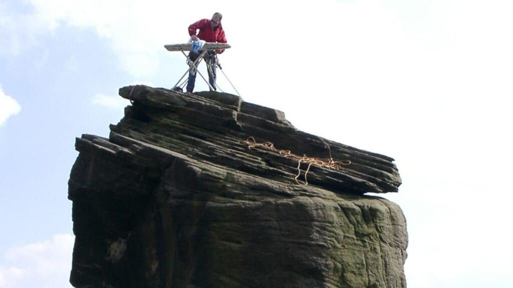 Extreme ironing on a giant boulder