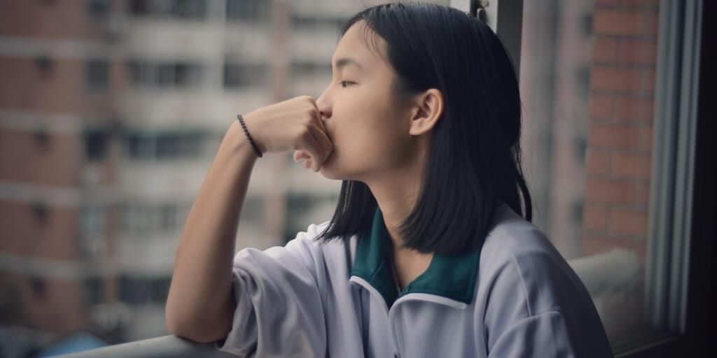 Girl thinking while looking out window by Chalis007 on Usplash