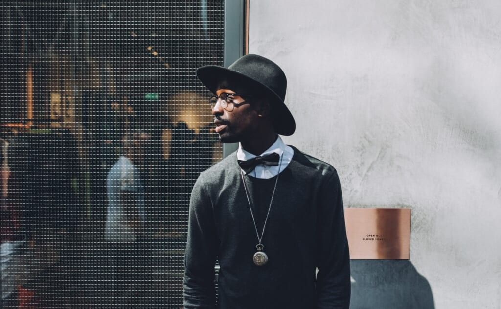 stylish man poses outside