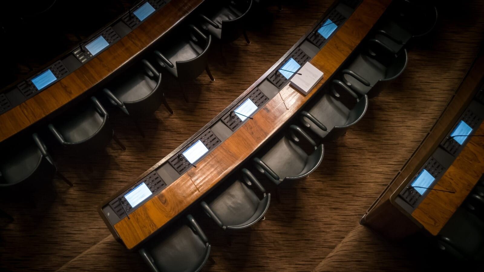 overhead view of lines of seats with tables before them