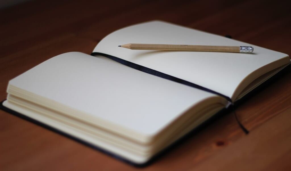 empty journal with pencil